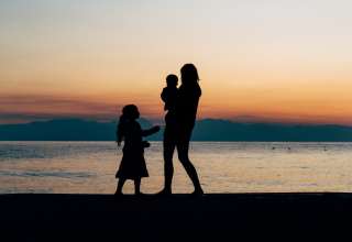 a mother and her kids on the beach