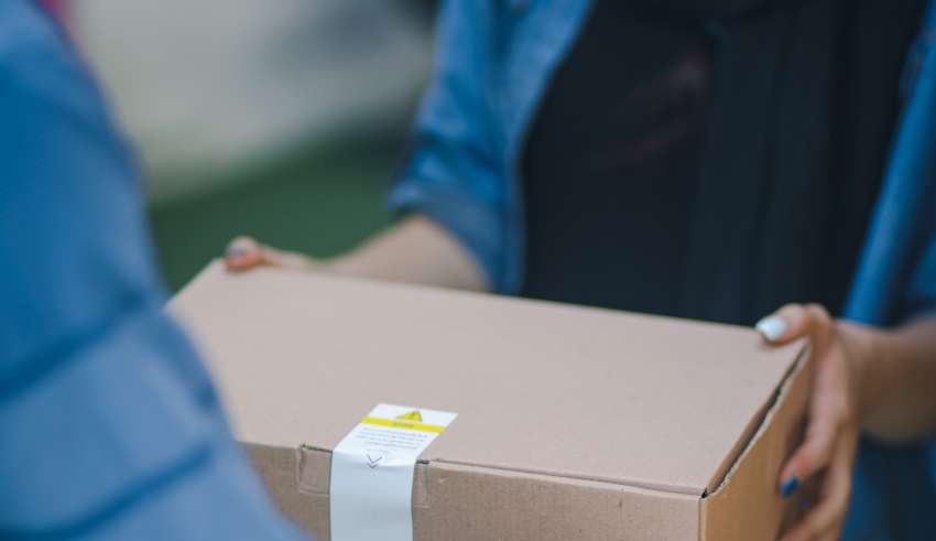 A woman accepting her delivery from a courier.