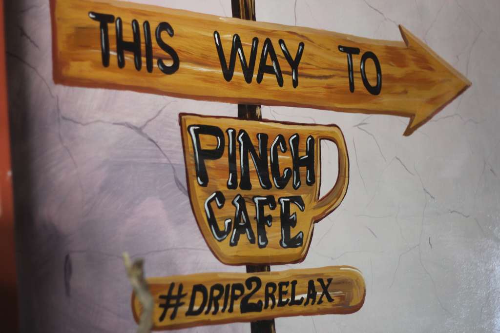 ALT TEXT: Pinch Cafe’s sign. Photo by Mikaela Bello