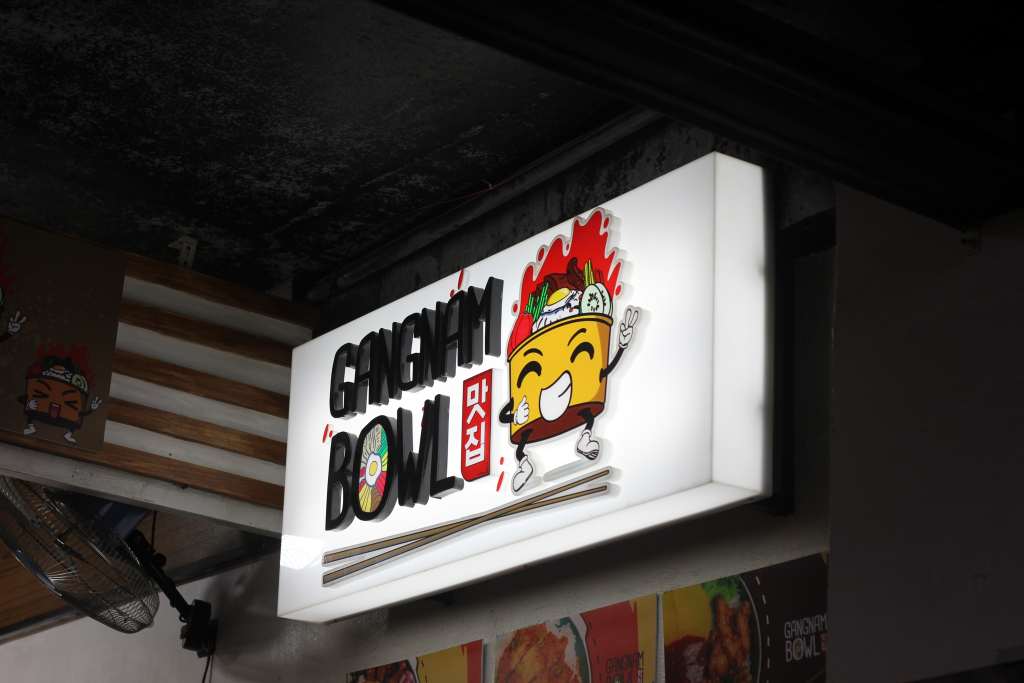 ALT TEXT: Gangnam Bowl logo. Photo by Mikaela Bello