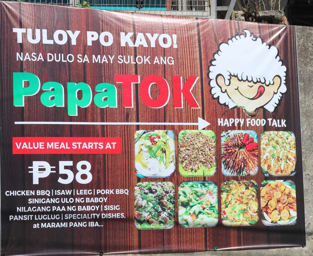 ALT TEXT: PapaTok tarpaulin with dishes they serve. Photo by Mikaela Bello