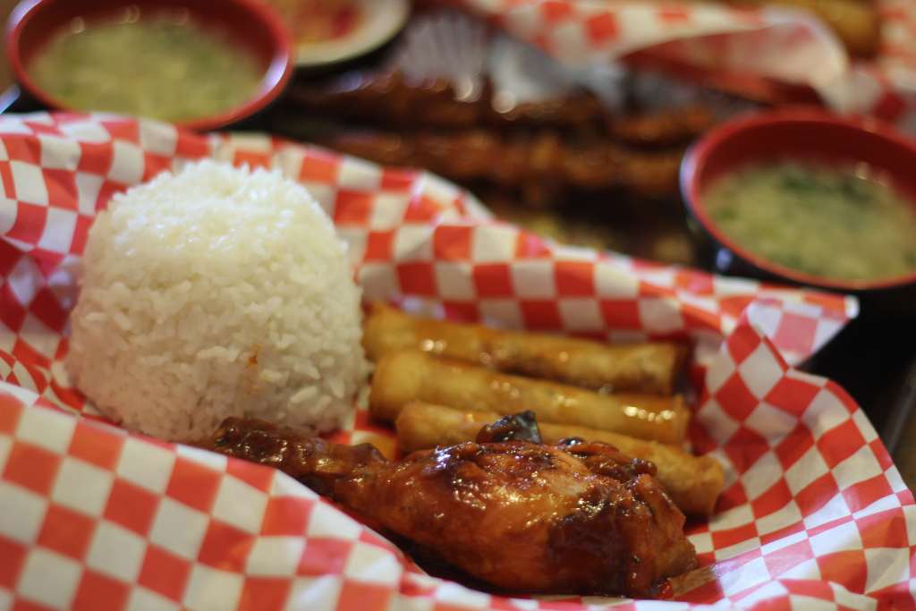 ALT TEXT: PapaTok grilled chicken with shanghai and rice. Photo by Mikaela Bello