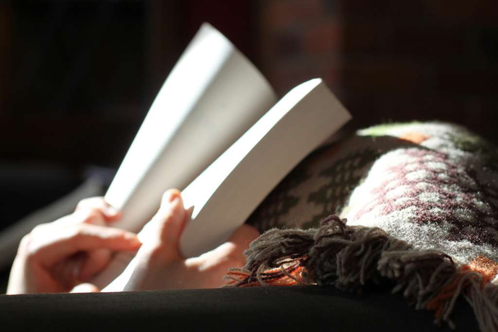 A reader flipping open a paperback book